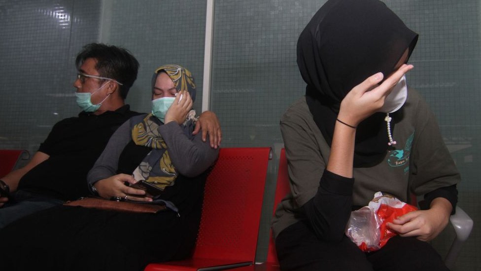 Relatives of passengers on board missing Sriwijaya Air flight SJY182 wait for news at the Supadio airport in Pontianak on Indonesia's Borneo island on January 9, 2021, after contact with the aircraft was lost shortly after take-off from Jakarta.