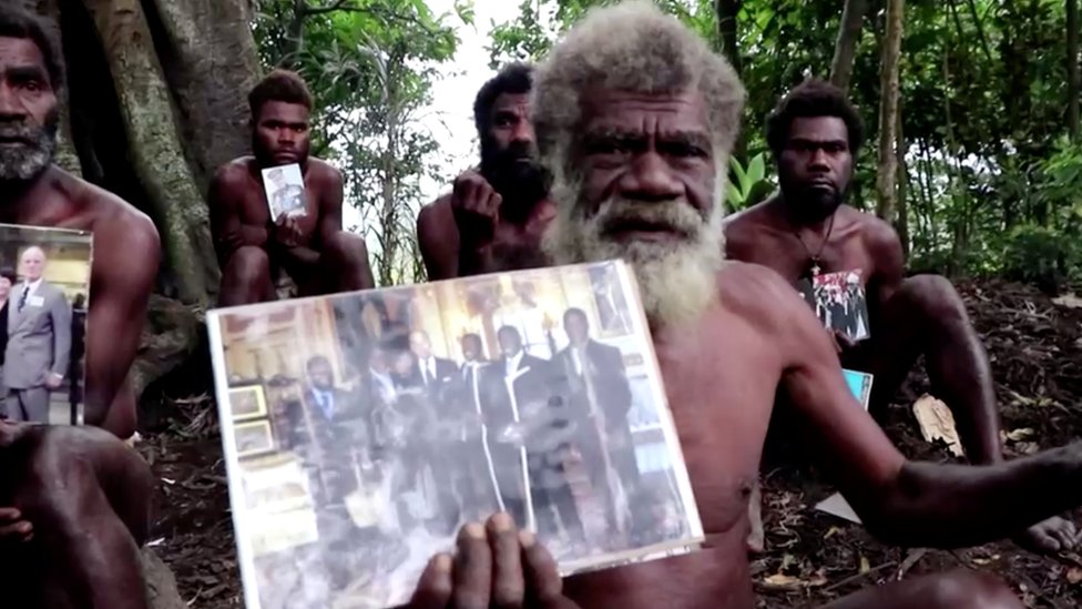 Ikunala village Chief Yapa hold foto of himself and four other local men wit Britain Prince Philip