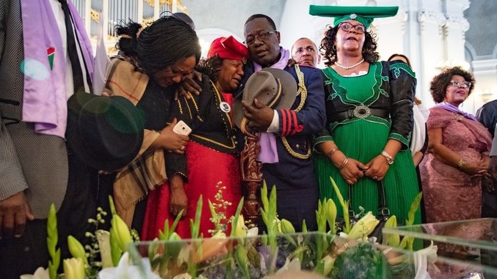 Members of a Namibian delegation mourn during a ceremony where human skulls are displayed in 2018 file photo
