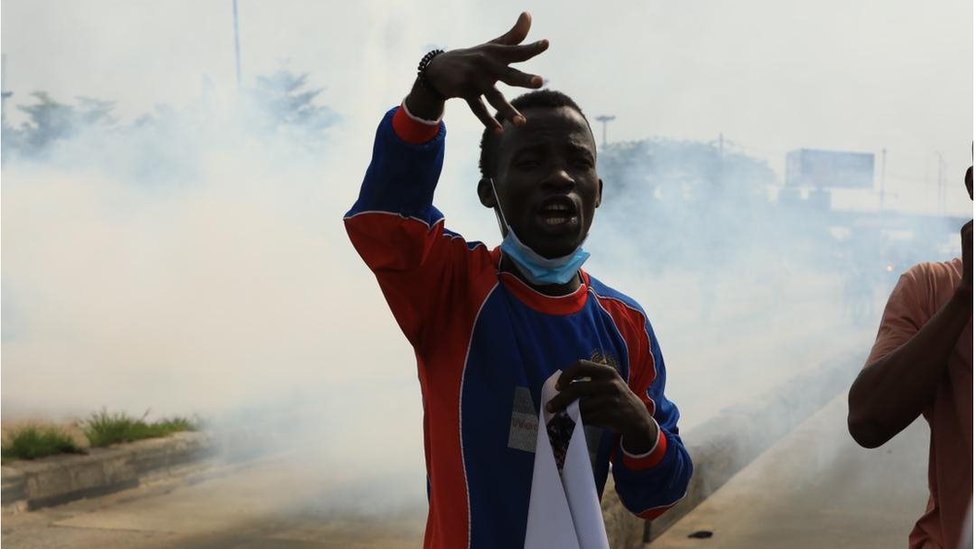 Protester stand in di midst of tear gas smoke for Ojota, Lagos on June 12, 2021 for Lagos
