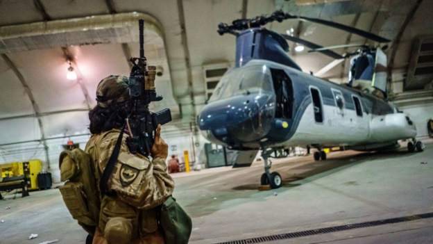 Taliban fighters dey inspect helicopters and oda military equipment, wey di US military say dem "disable" before dem withdraw