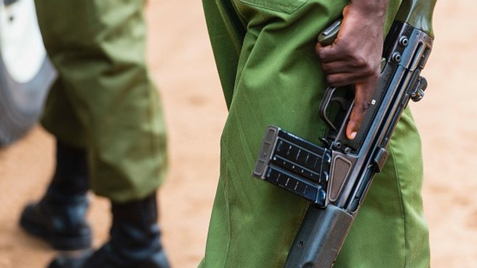 Kenyan police officer with gun