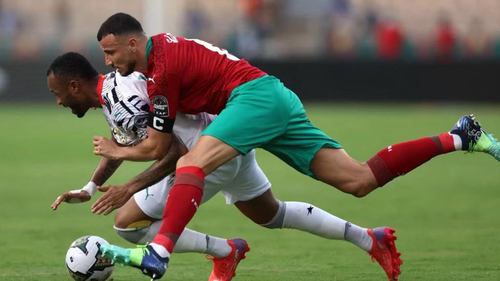 Morocco defender Romain Saiss dey try stop Ghana forward Jordan Ayew
