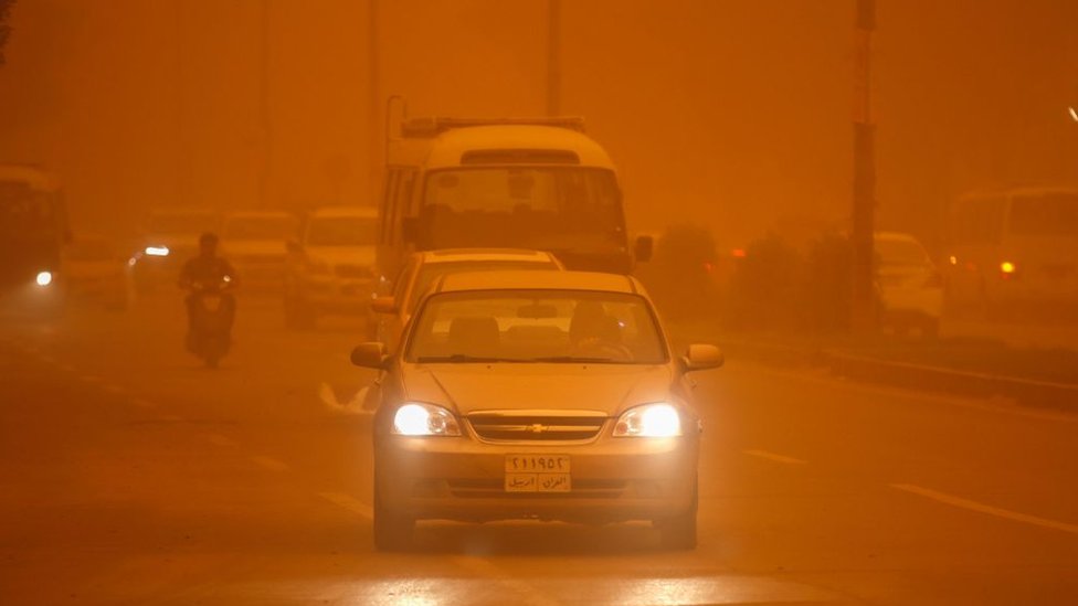 Vehicles drive along a road during a severe dust storm in Iraq's capital Baghdad