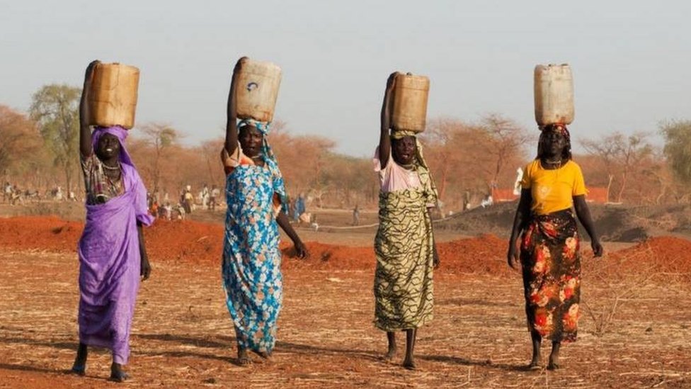 Women wey dey carry water for head