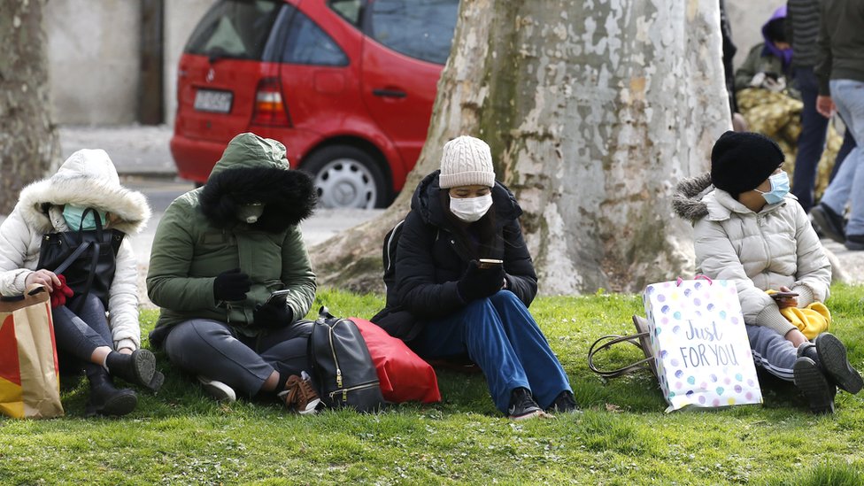 Croatians wear face masks as they sit outside
