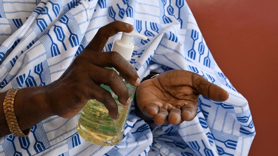 Woman applies hand sanitiser