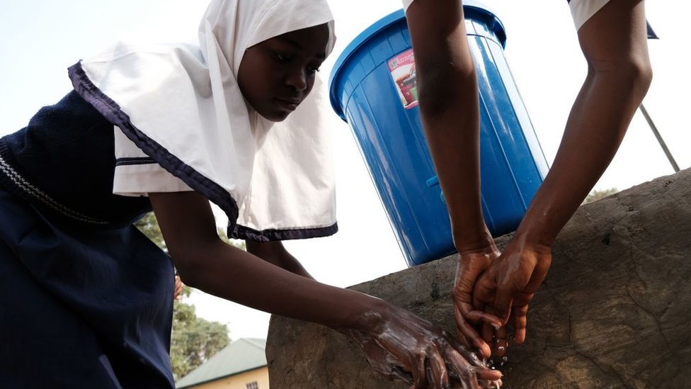 A girl washes her hands in Abuja on 20 March