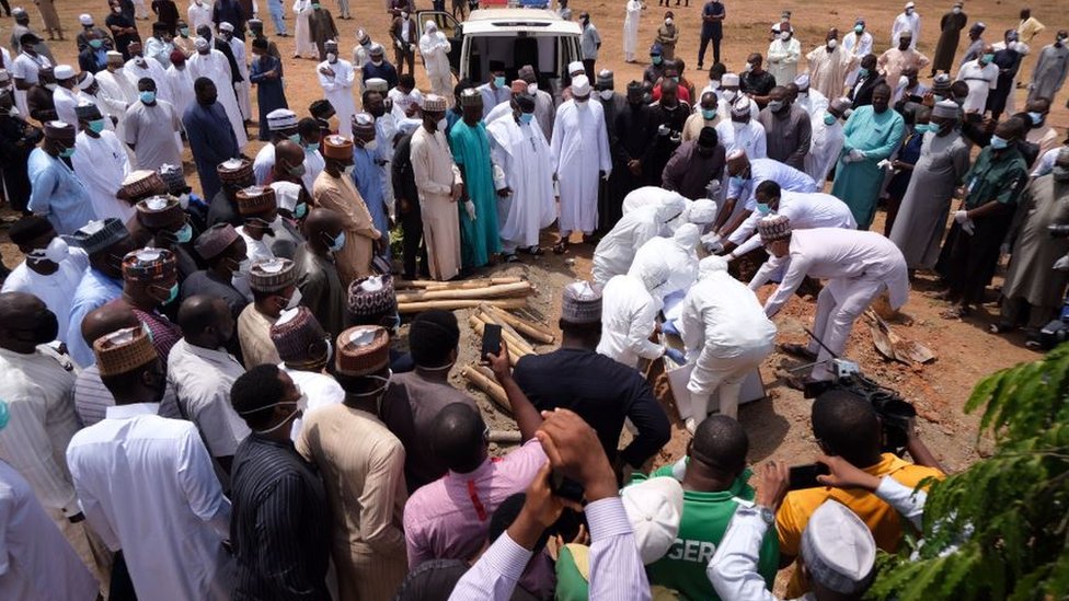 Health workers prepare to bury the remains of Nigerias Chief of Staff (COS), Abba Kyari