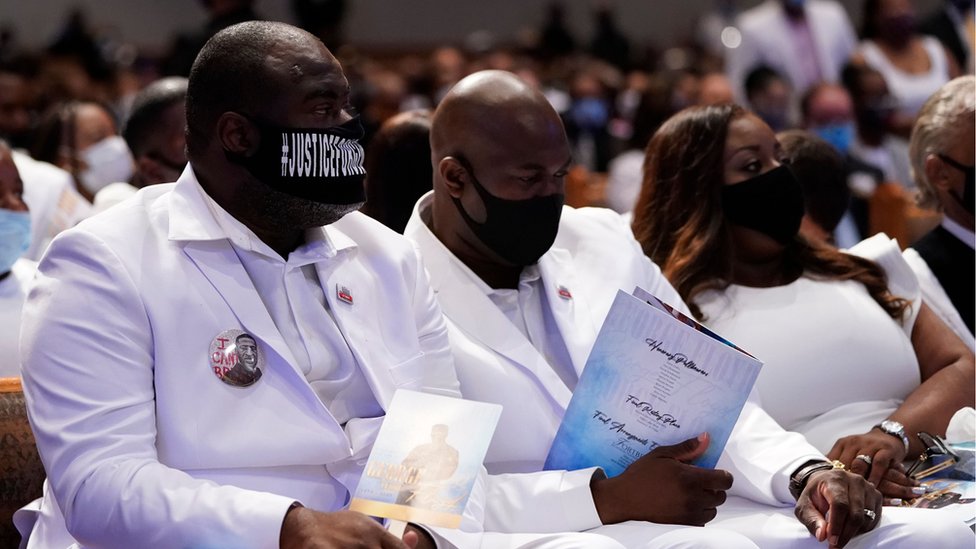 Image shows Rodney Floyd (L) and Philonise Floyd (C) brothers of George Floyd, attending their brother's funeral service