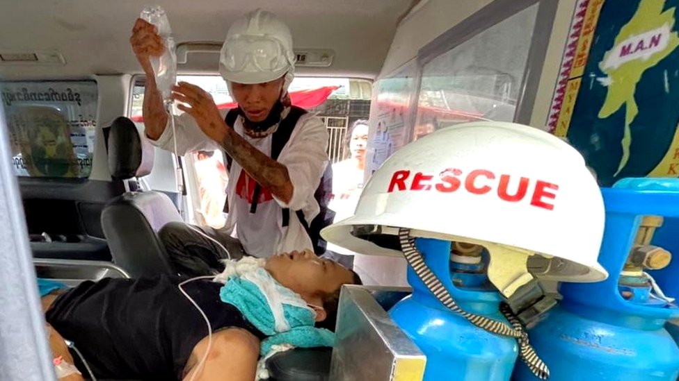 Emergency workers treat injured man for Yangon Hledan township