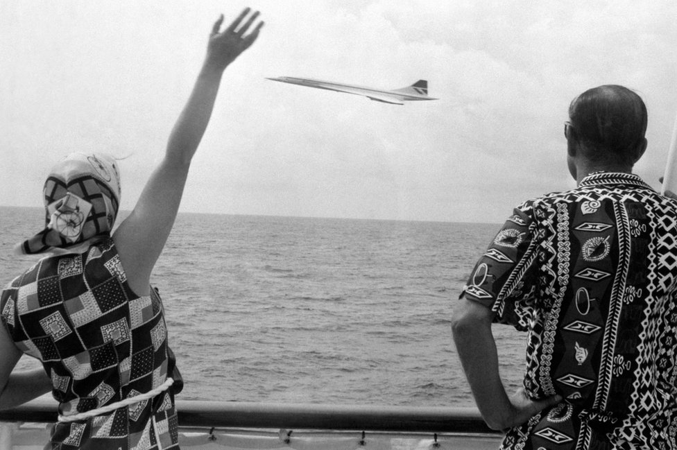 Queen Elizabeth II and di Duke of Edinburgh wave as Concordefly pass di Royal Yacht Britannia as di royal couple near Barbados