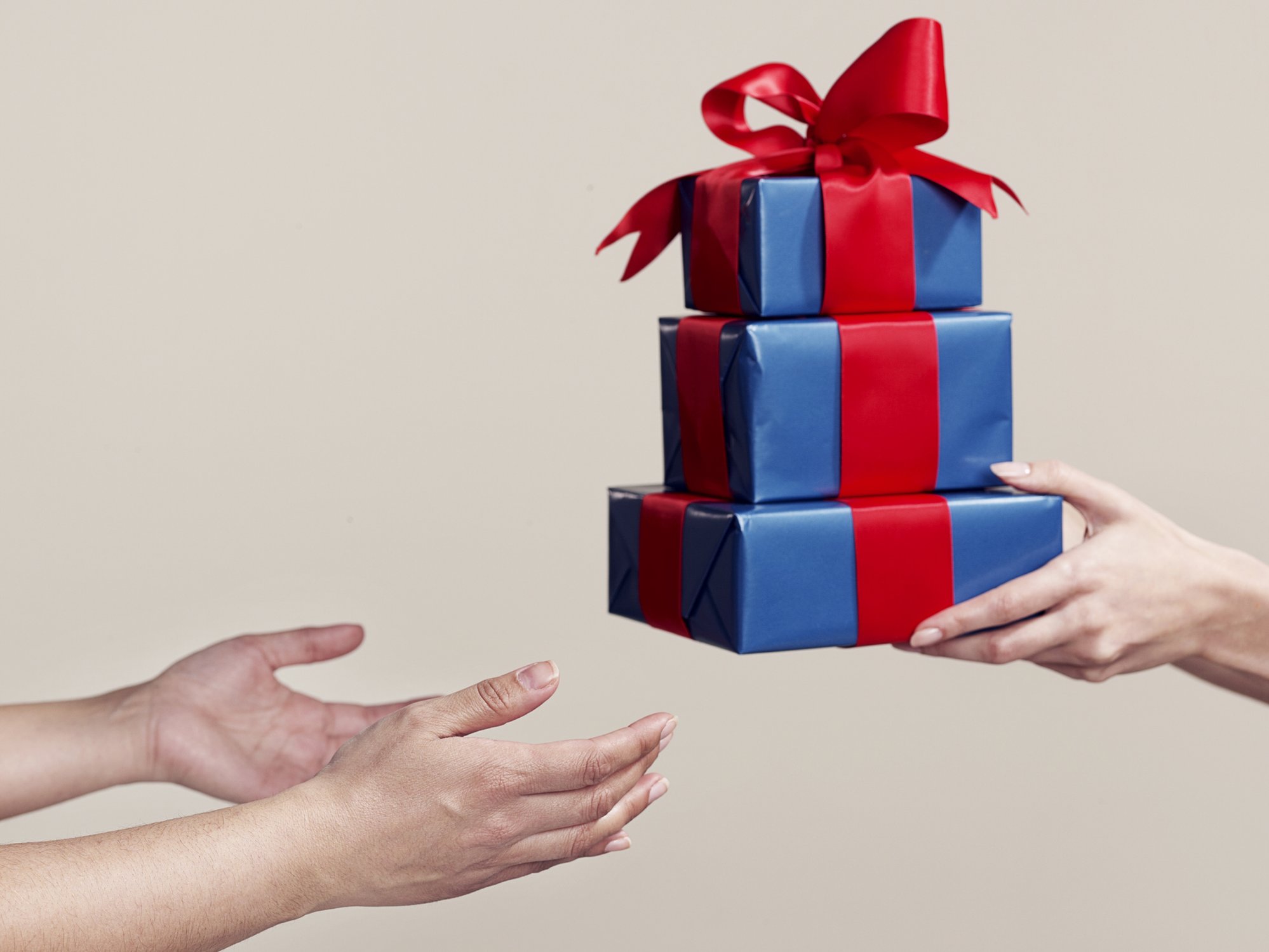 One pair of hands offers presents to another
