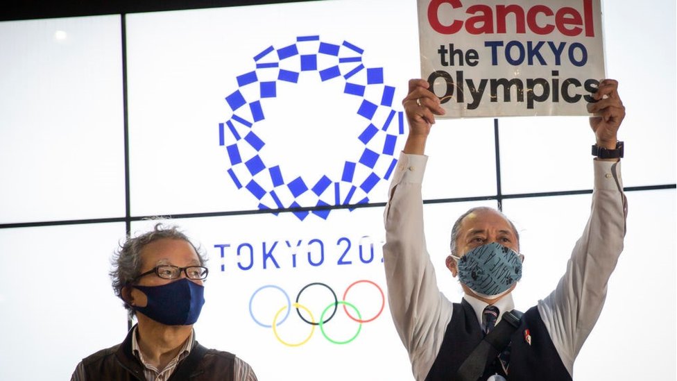 A protester holds a placard during a protest against the Tokyo Olympics on May 17, 2021 in Tokyo, Japan