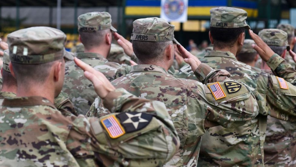 Na US soldiers dey dis foto for di opening ceremony of di "Rapid Trident-2018" international military exercise for Starytchi, outside Lviv on September 3, 2018.