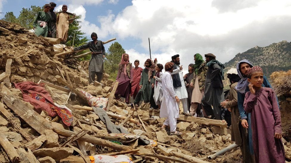 Villagers help di search and rescue operation by going through di remains of one destroyed building for Paktika