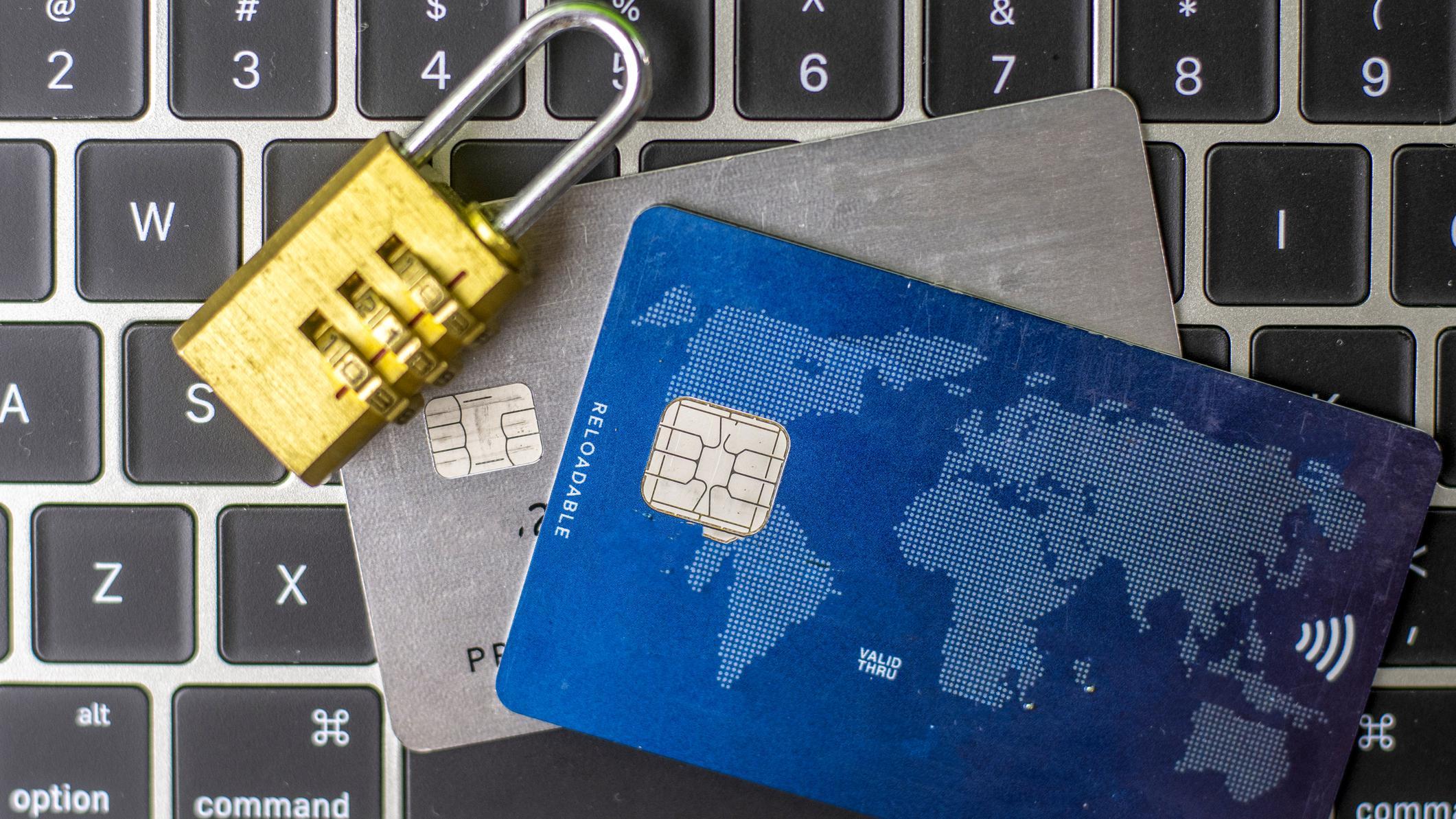 laptop and ATM cards with padlock