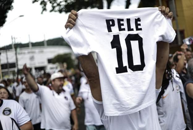 Pesin hold up number 10 jersey wit Pele name