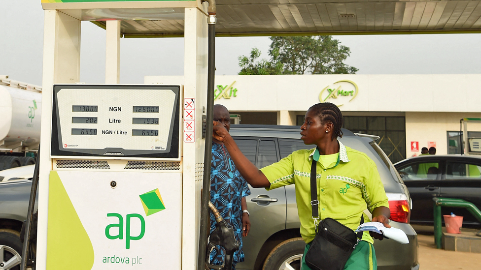 One attendant sell diesel to one motorist for one filling station for Warewa, along Lagos-Ibadan expressway, Ogun State, south-west Nigeria - March 2022