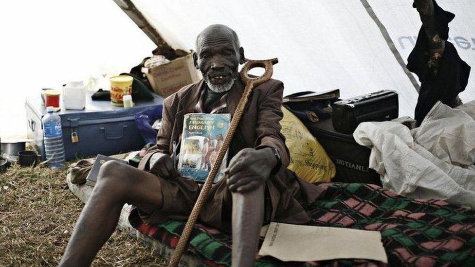 Kimani Maruge, siddon inside tent for camp for internally displaced persons for Eldoret.