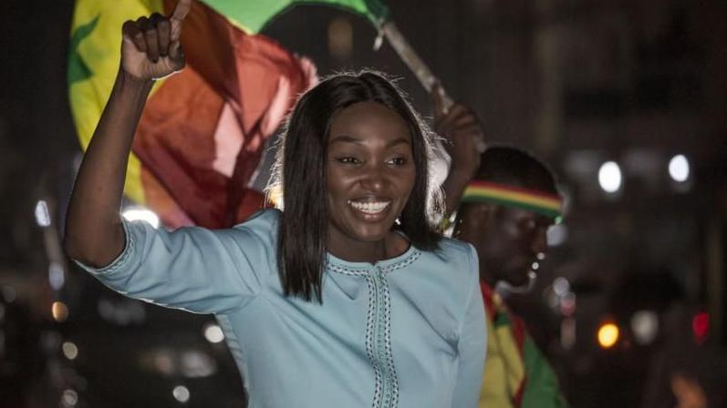 Senegalese presidential candidate Anta Babacar wave to supporters from vehicle during rally for Dakar, Monday, March 11, 2024.