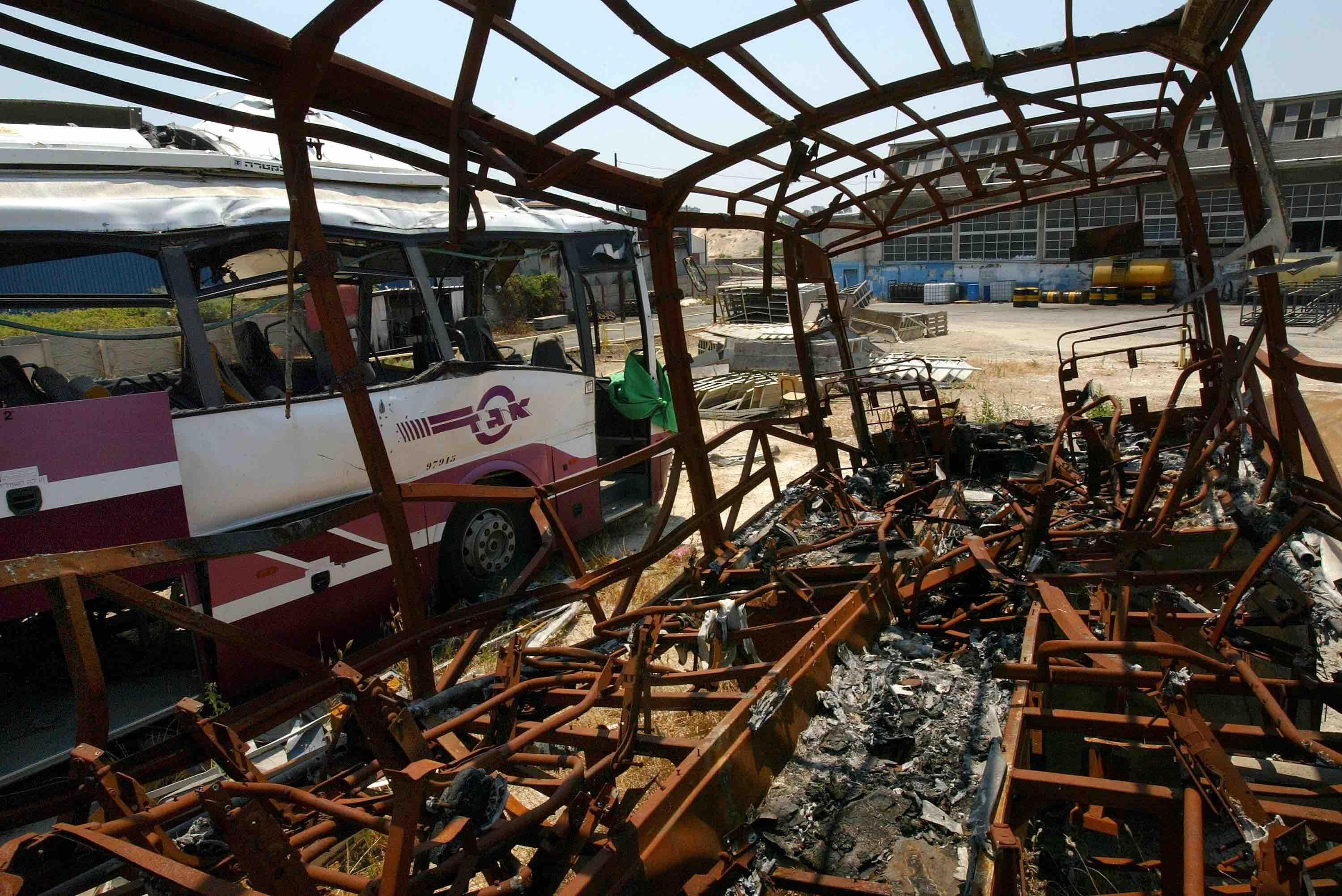 Israeli passenger buses blown up by Palestinian suicide bombers dey wait to dey scrapped for a bus graveyard for di Egged bus facility on 30 June 30 2003 for Qiryat Atta, northern Israel