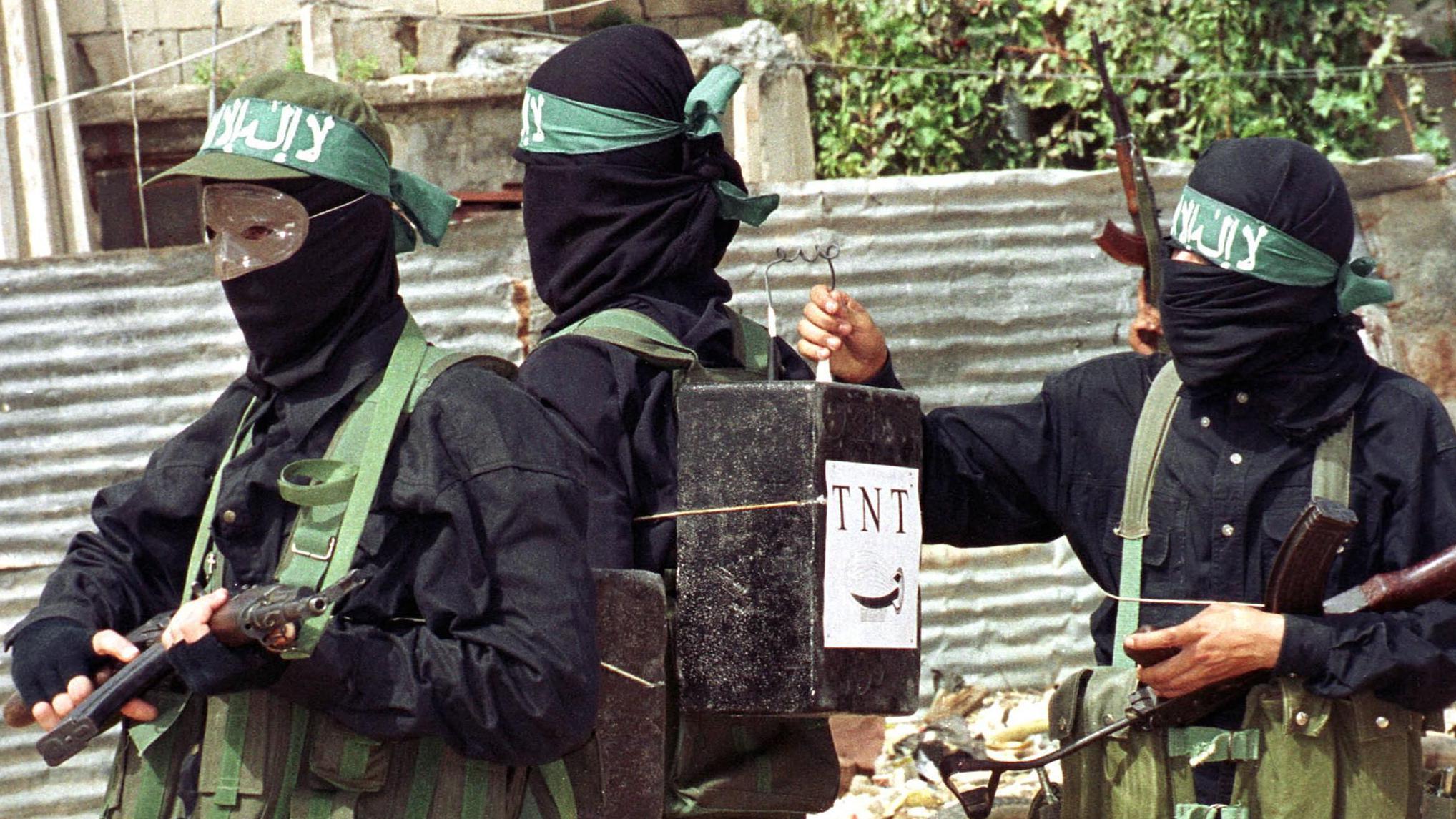 One Palestinian militant strap boxes, mark as TNT explosives, on di back of one of im comrades, clearly as a sign say dem dey prepare to carry out suicide bombings, during anti-Israeli protest for di Palestinian refugee camp of Ain al-Hilweh for di outskirts of di southern Lebanese port of Sidon October 2000