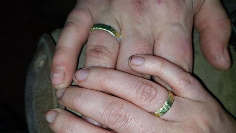 Valeria and Andriy's dia hands wit wedding rings on 