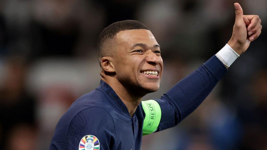 Kylian Mbappe smiling while playing for France