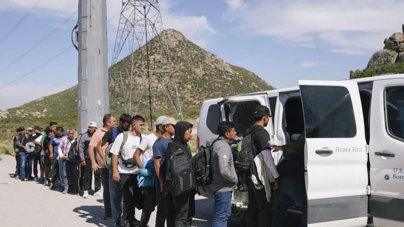 Migrants being processed at the US-Mexico border on 9 June