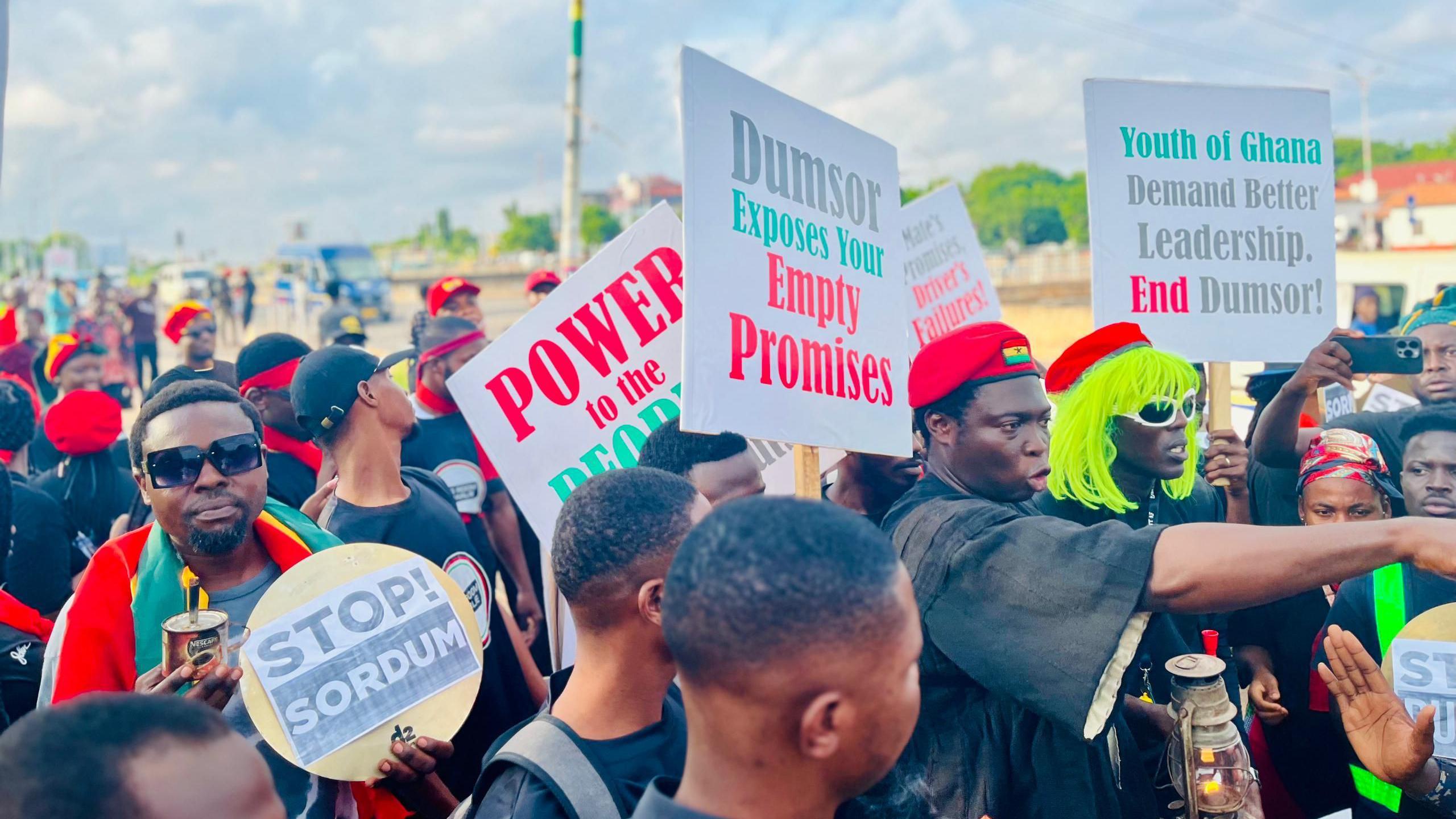 Protesters wit a placard