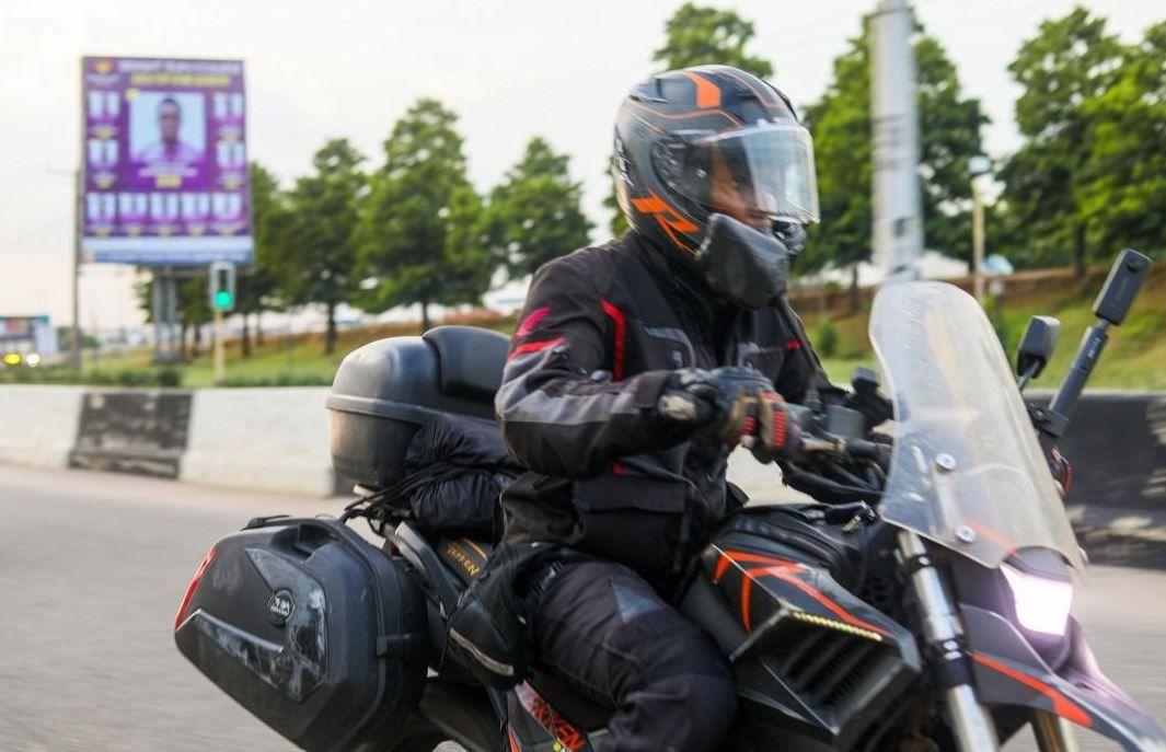  Ebaide riding her motorbike in a black track suit