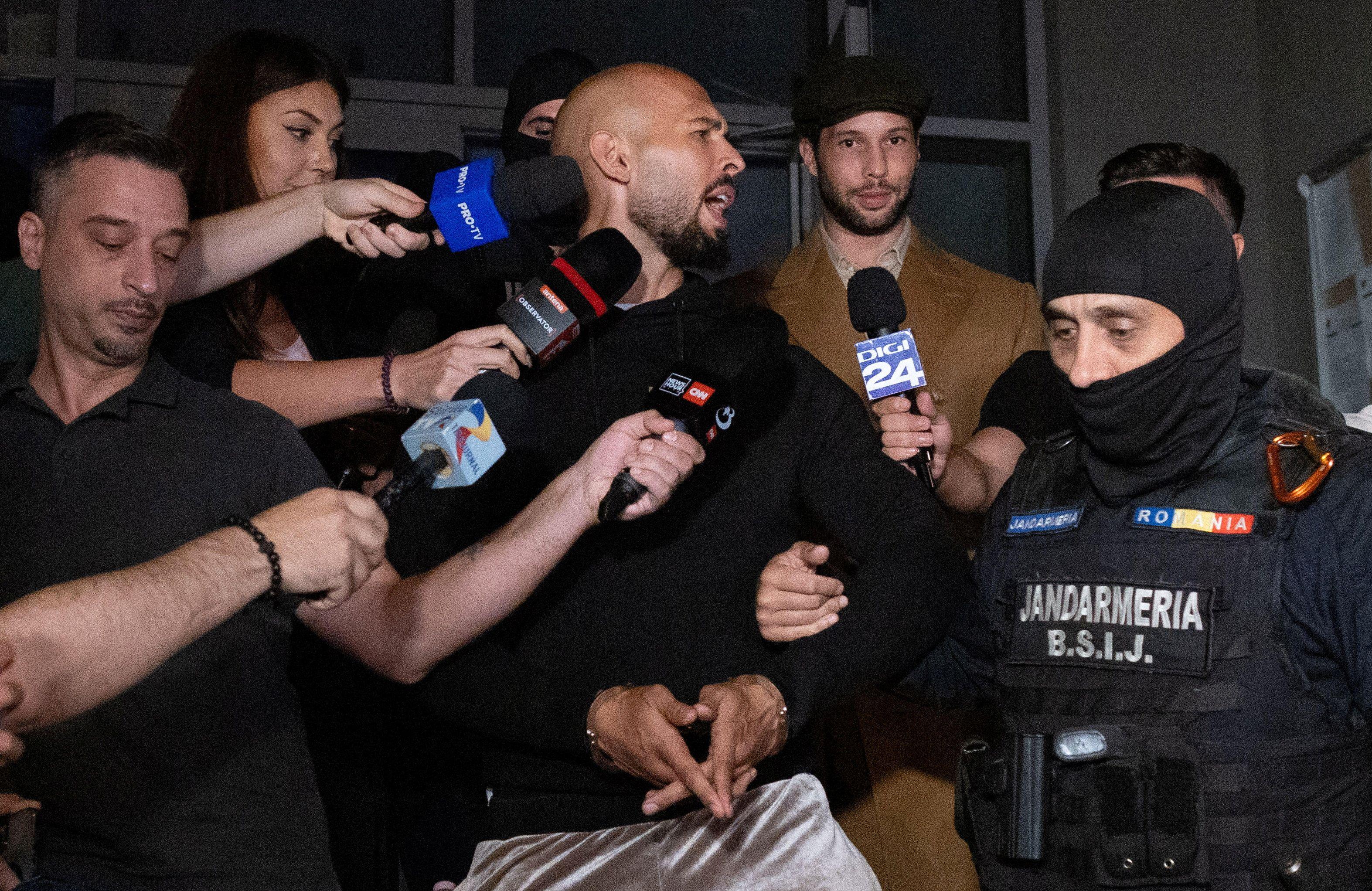 Andrew Tate and his brother Tristan are escorted outside the Directorate for Investigating Organized Crime and Terrorism (DIICOT), in Bucharest, Romania, August 21, 2024. 