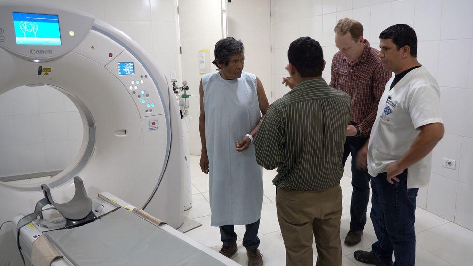 CT scanner with a group of people standing next to it