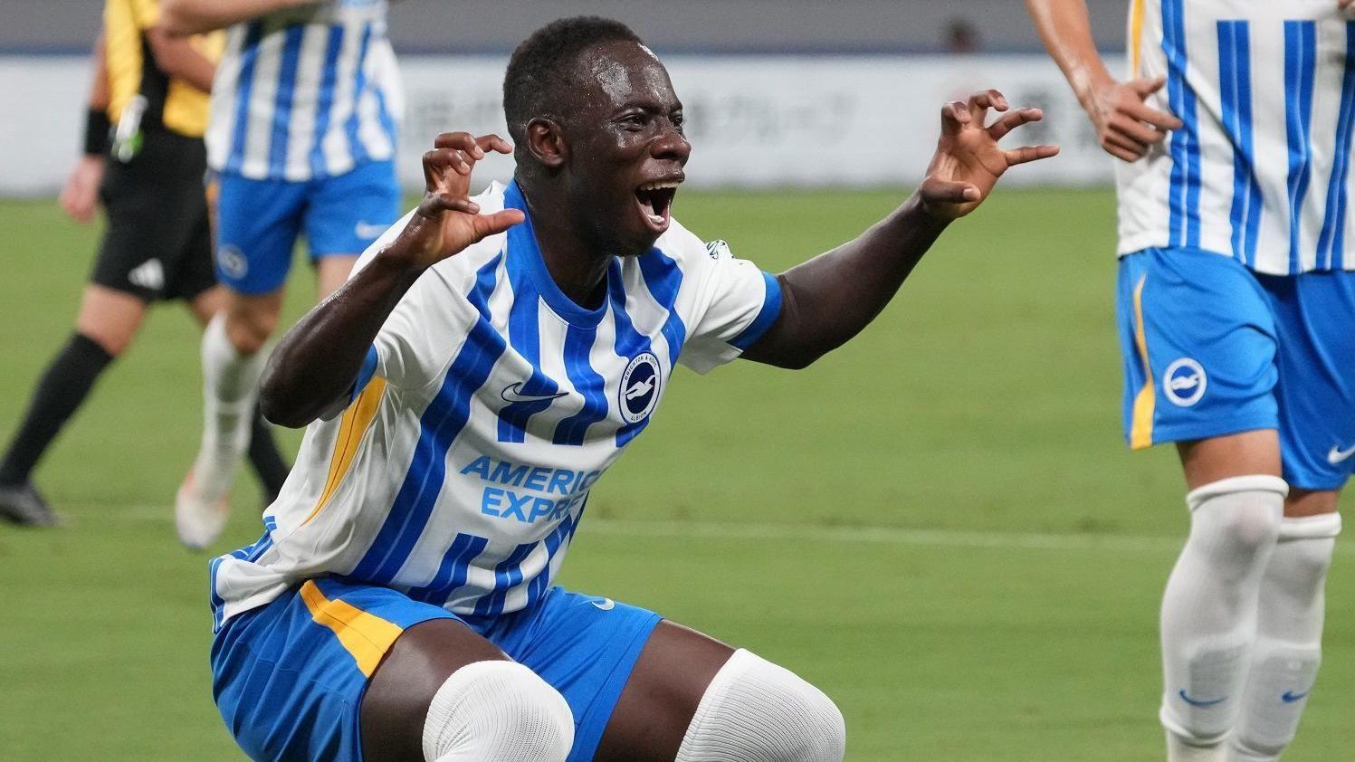 Brighton forward Yankuba Minteh bin celebrate a goal for pre-season friendly by making claws wit im hands and roaring towards a camera