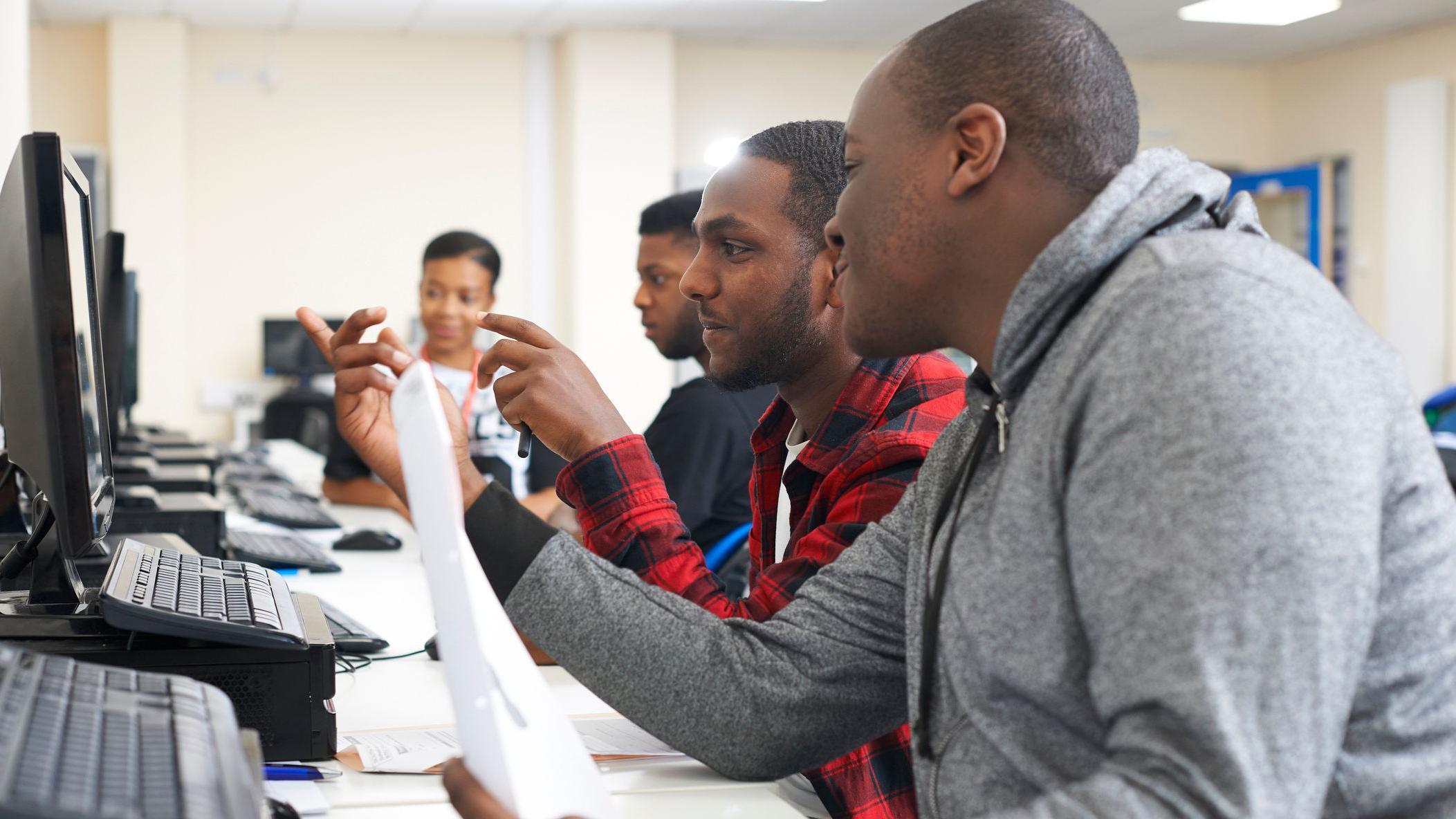 Youths going through computer