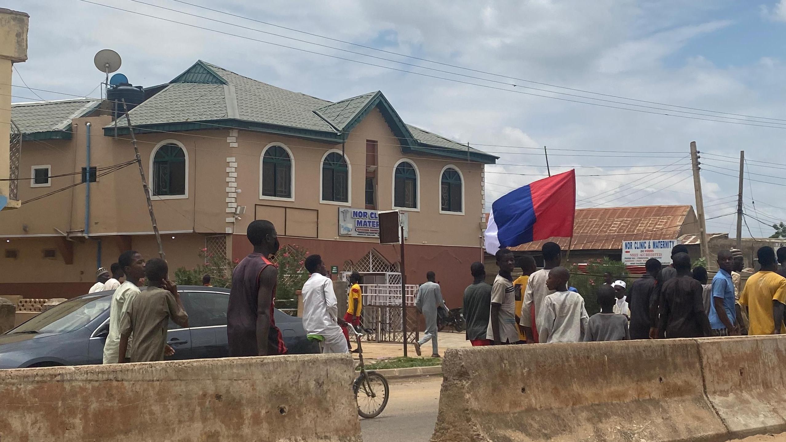 Protesters carrying Russian flag for Kano