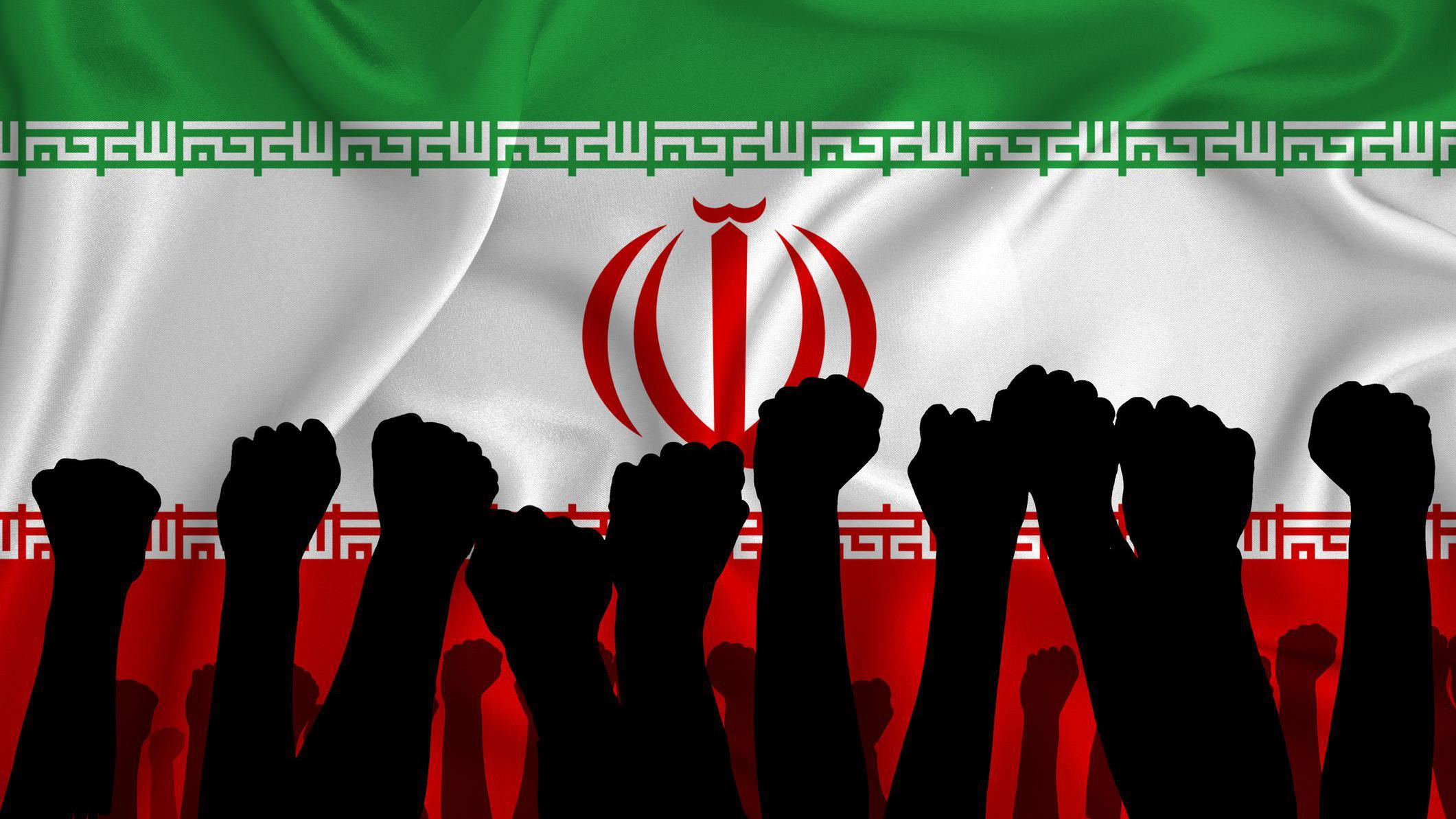 Silhouette of raised arms and clenched fists on the background of the flag of Iran