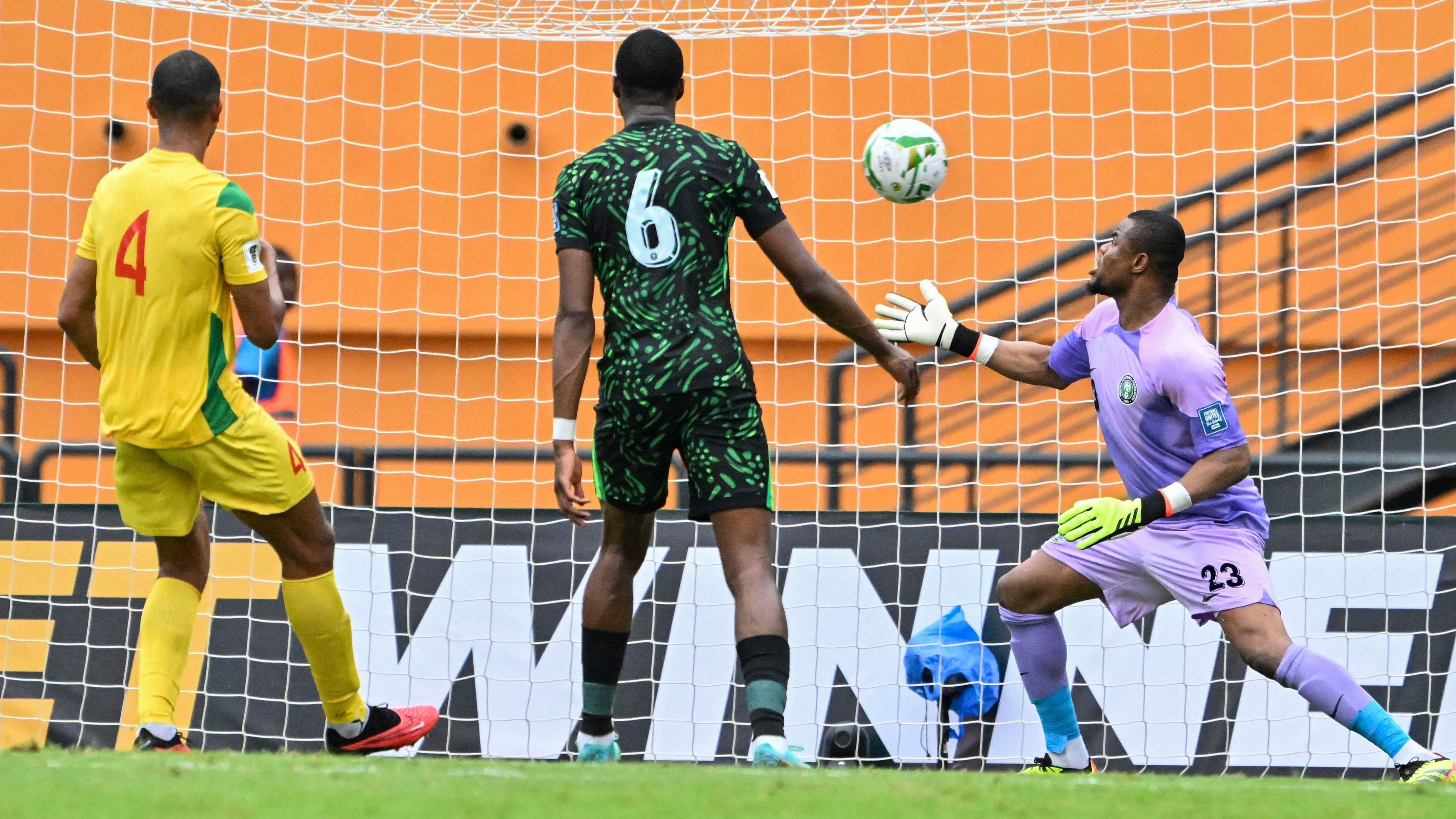 Nigeria goalkeeper Stanley Nwabali, wear purple kit, shock as di ball enta inside di net during dia game against Benin