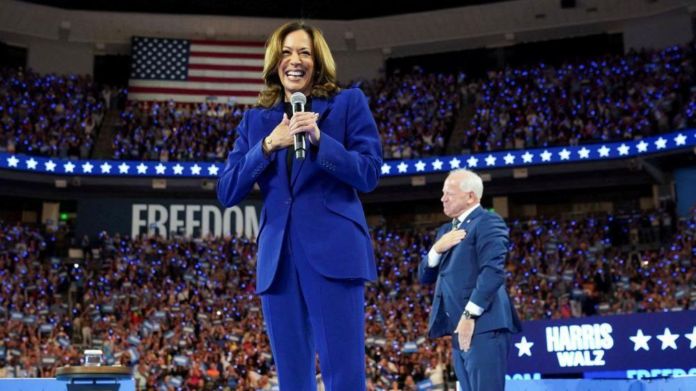 Kamala Harris and Tim Walz stand in front of crowd in Milwaukee