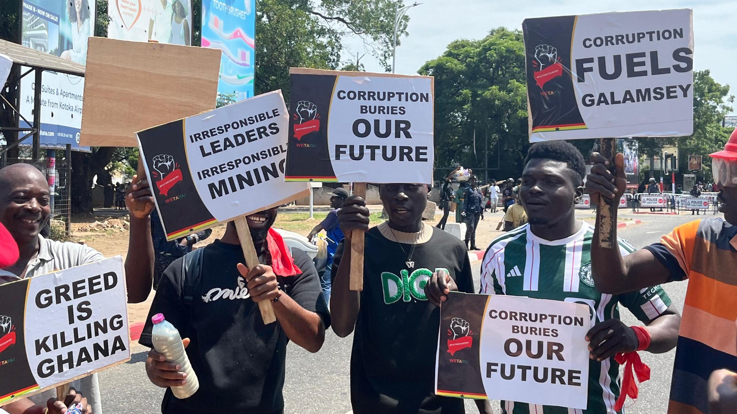 Protesters carrying placards against illegal gold mining