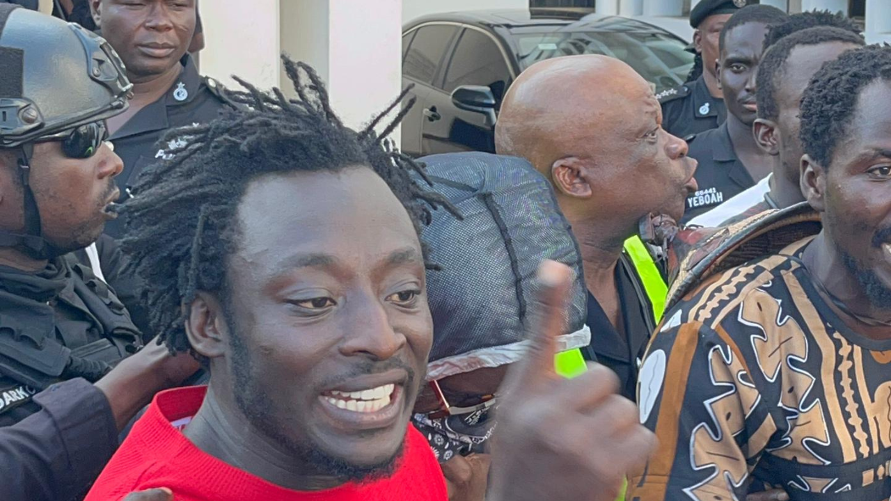 Photo of one of di lead conveners Ralph St. Williams being escorted into a waiting police van