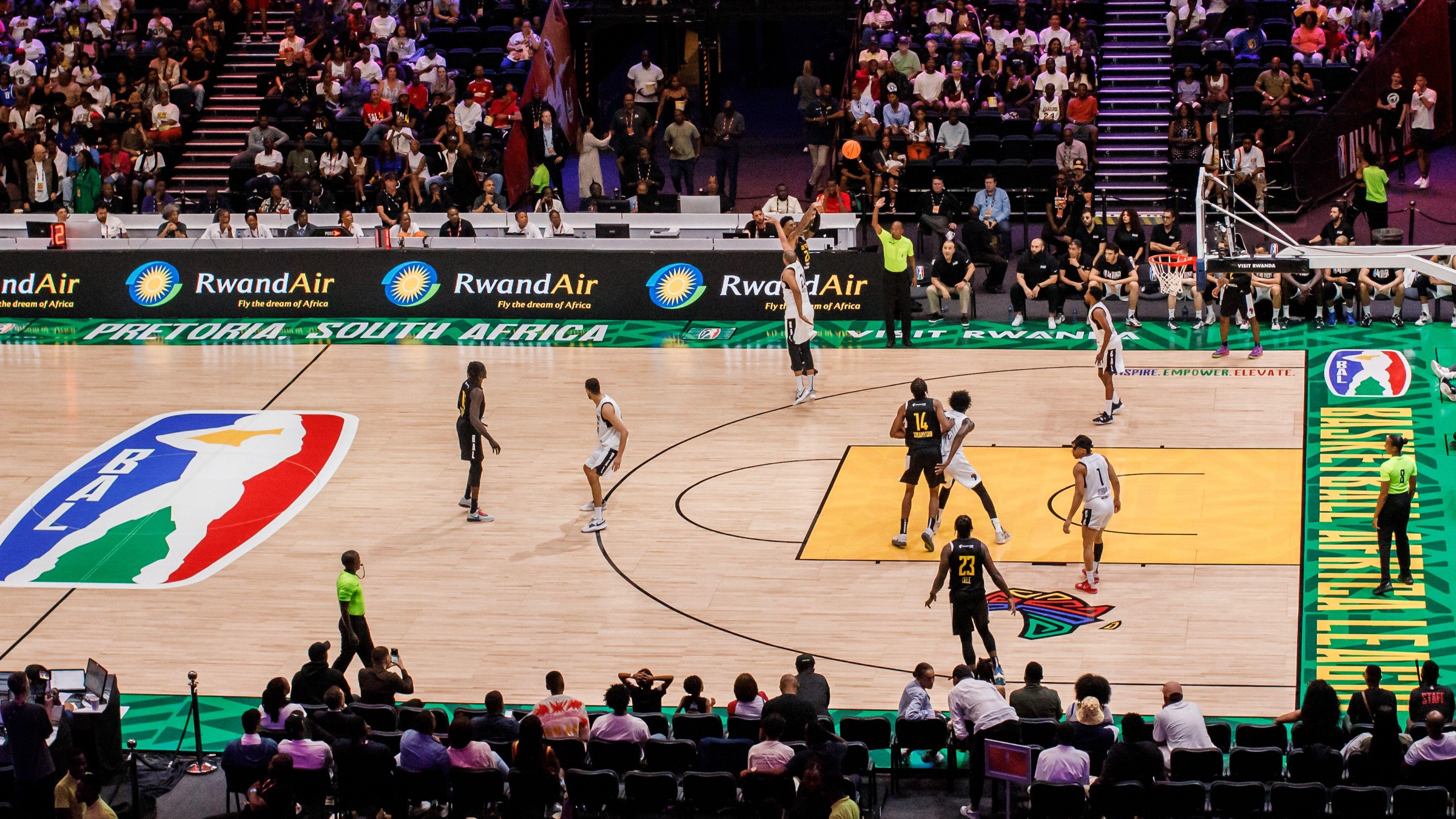 A basketball game is played on a Basketball Africa League branded court