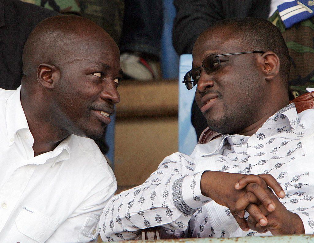 Charles Blé Goudé and Guillaume Soro sit and talk at an event in 2007.
