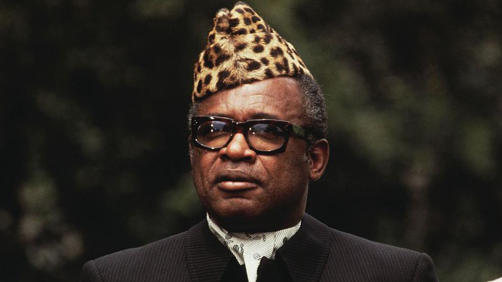 Former President of the Democratic Republic of Congo Mobutu Sese Seko wear one leopard-skin hat, glasses and one dark suit and cravat