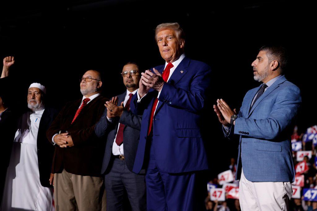 Republican presidential nominee, former U.S. President Donald Trump stand wit supporters on stage during campaign rally for Suburban Collection Showplace on October 26, 2024 for Novi, Michigan.