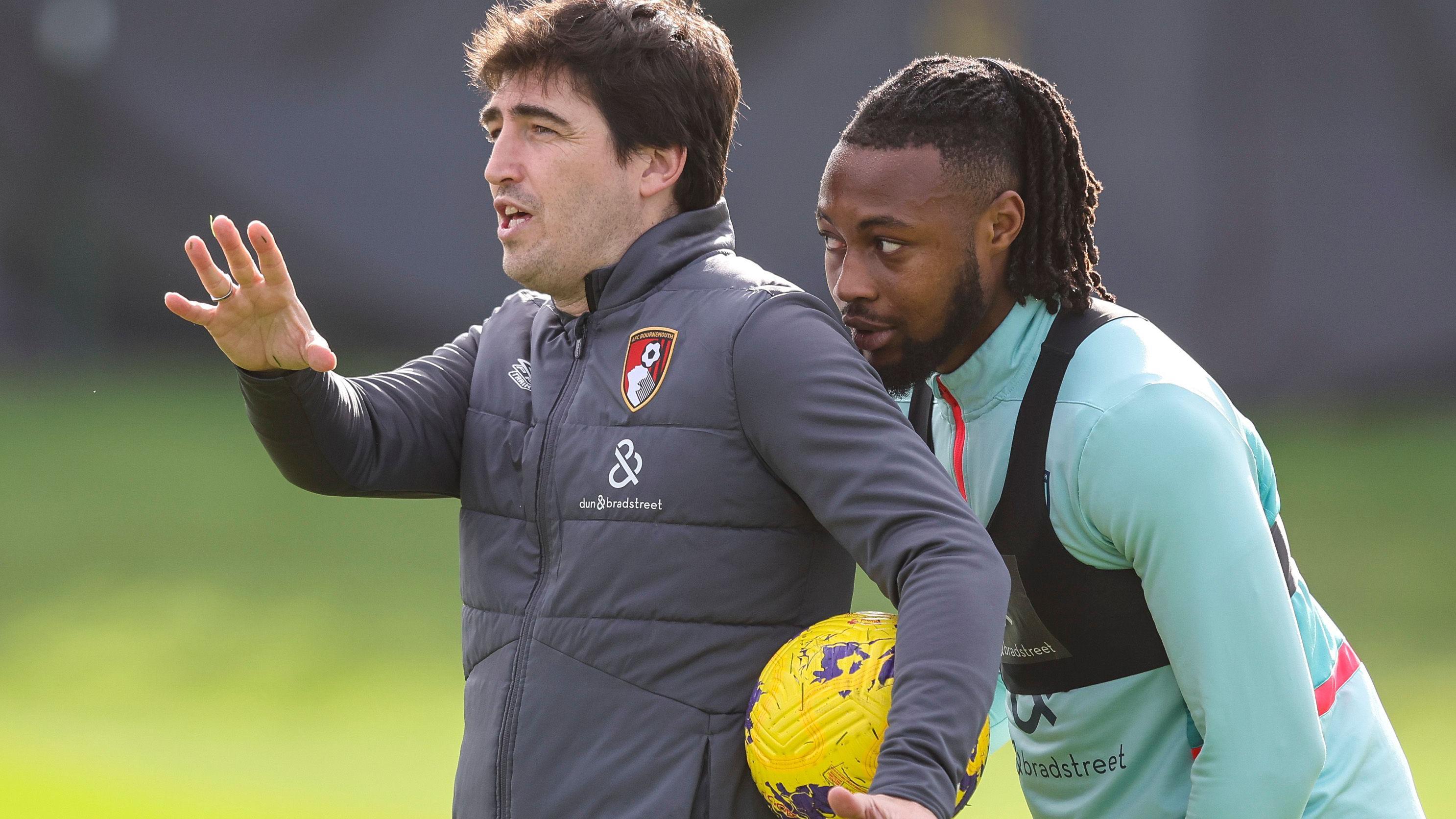 Antoine Semenyo lean in behind di left shoulder of Andoni Iraola, wey dey gesture wit im right hand as im hold yellow football between im left arm 