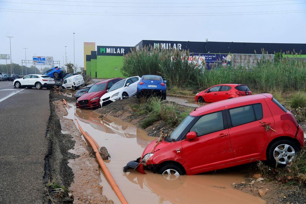 Destroyed cars in a flooded ditch